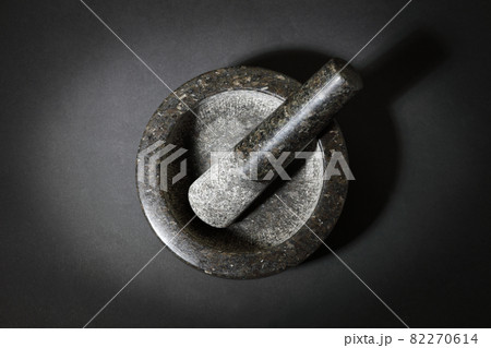 Top view of mortar and pestle on dark surface 82270614