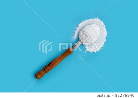 Baking soda on blue background. 82276940