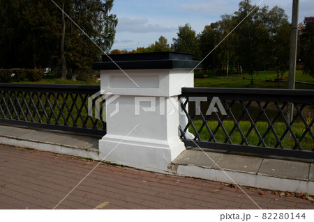 Wrought-iron fence on the bridge in the park on an autumn day Wrought-iron fence on the bridge in the park on an autumn day 82280144