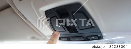 Man with his finger pressing emergency button in car closeup 82283004