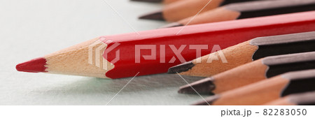 Red sharp wooden pencil lying beyond black closeup background Red sharp wooden pencil lying beyond black closeup background 82283050