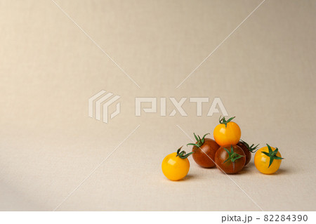 cherry tomatoes at the linen background colored cherry tomatoes at the linen background colored 82284390