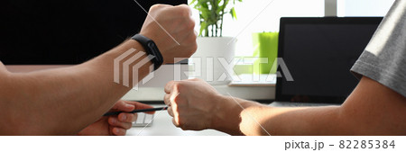 Male hands are joined by fists in working office close-up 82285384
