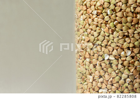 green buckwheat grains close-up on beige background colored green buckwheat grains close-up on beige background colored 82285808