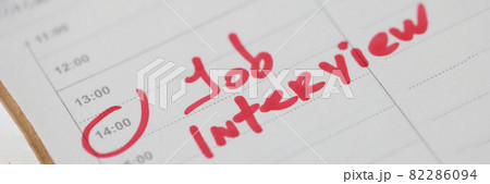 Job interview note written in red marker in diary closeup 82286094