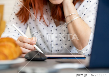 woman draws on a digital tablet with a touch screen. no face close-up woman draws on a digital tablet with a touch screen. no face close-up 82286222