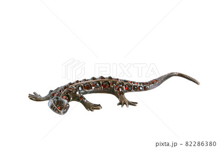 Jewelery - lizard figurine made of metal with natural grenades, isolation Jewelery - lizard figurine made of metal with natural grenades, isolation 82286380