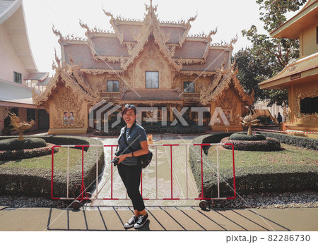A tourist posing for a photo in Wat Rong Khun  or White Temple in Chiang rai, Thailand 82286730