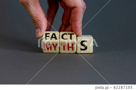 Facts or myths symbol. Businessman hand turns cubes and changes the word 'myths' to 'facts'. Beautiful grey background, copy space. Business and facts or myths concept. 82287105