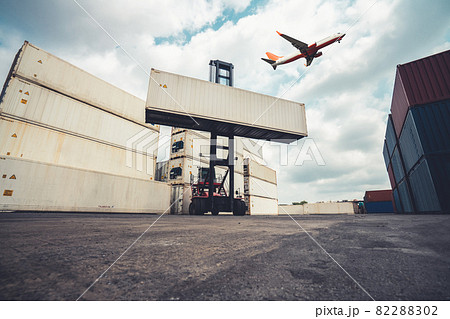 Cargo container for overseas shipping in shipyard with airplane in the sky . 82288302