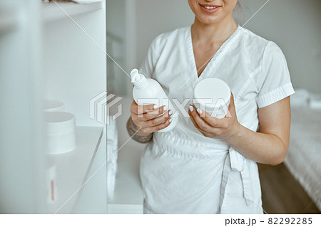 beautiful happy caucasian female masseur is posing in white minimalistic modern treatment salon beautiful happy caucasian female masseur is posing in white minimalistic modern treatment salon 82292285