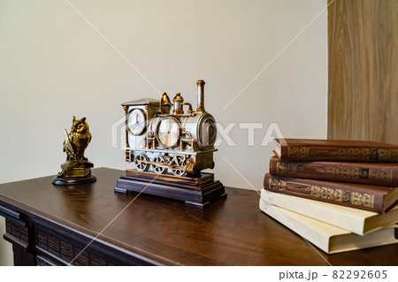 metal sculpture of an owl and a clock in the form of a steam locomotive.  82292605