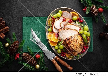 Christmas turkey dinner. Christmas turkey with decorations on black background, top view. 82296599