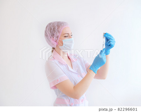 COVID-19 vaccine in researcher hands, female doctor holds syringe and bottle 82296601