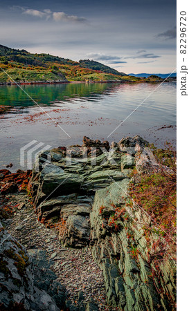 Beautiful sunset at Ensenada Zaratiegui Bay in Tierra del Fuego National Park, near Ushuaia and Beagle Channel, with geological mineral deposits, Patagonia, Argentina, early Autumn. 82296720
