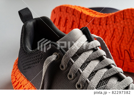 Elastic laces of gray mesh fabric sneakers close-up. 82297382