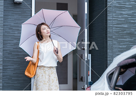 若い女性　玄関　傘　困る 82303795
