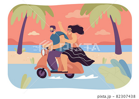 Happy man and woman riding motorbike along seaside 82307438