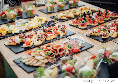 Buffet table of reception with cold snacks, meat and salads 82310127