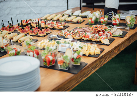 Buffet table of reception with cold snacks, meat and salads 82310137