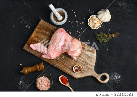 Raw turkey wing on cutting board 82311633