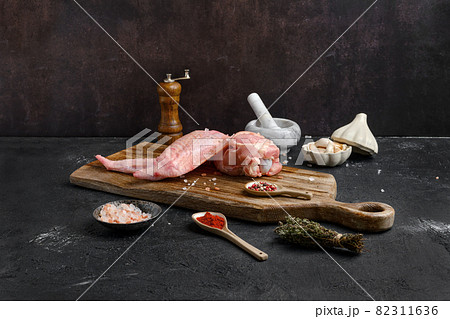 Raw turkey wing on cutting board 82311636