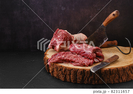 Pieces of raw lamb neck on cutting stump in slaughterhouse Pieces of raw lamb neck on cutting stump in slaughterhouse 82311657