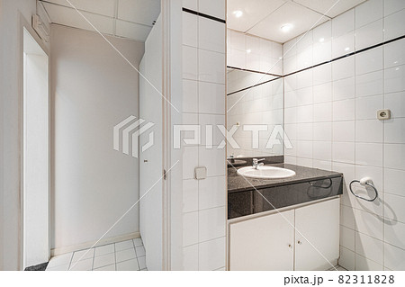 Interior of bathroom in office. Public white restroom with sink, faucet and mirror. 82311828