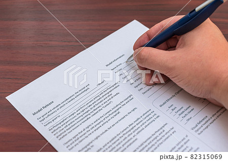 Signing a model release for permission to publish photos 82315069