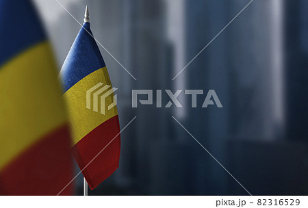 Small flags of Romania on a blurry background of the city Small flags of Romania on a blurry background of the city 82316529