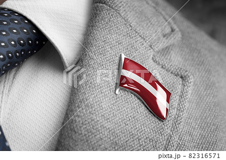 Metal badge with the flag of Latvia on a suit lapel 82316571