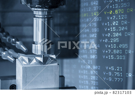 The abstract scene CNC milling machine cutting the stamping die parts and G-code data background. The abstract scene CNC milling machine cutting the stamping die parts and G-code data background. 82317103