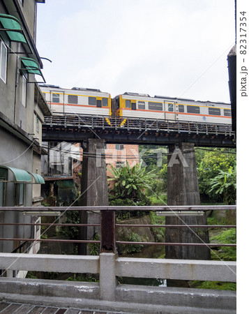 Train of Pingxi Railway Line traveling in Pinghsi old street, New Taipei City, Taiwan 82317354