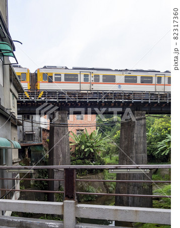 Train of Pingxi Railway Line traveling in Pinghsi old street, New Taipei City, Taiwan 82317360