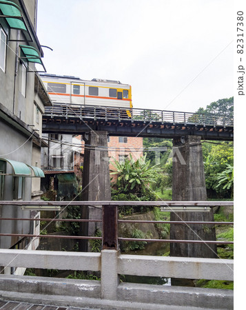 Train of Pingxi Railway Line traveling in Pinghsi old street, New Taipei City, Taiwan 82317380