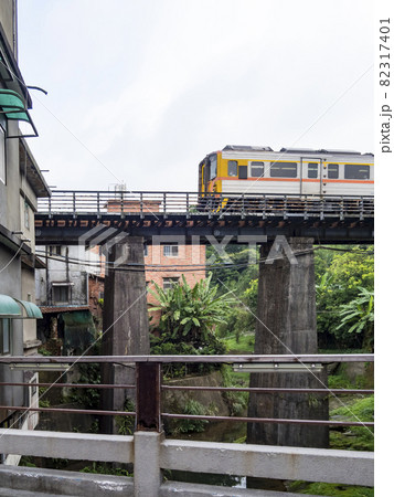 Train of Pingxi Railway Line traveling in Pinghsi old street, New Taipei City, Taiwan Train of Pingxi Railway Line traveling in Pinghsi old street, New Taipei City, Taiwan 82317401