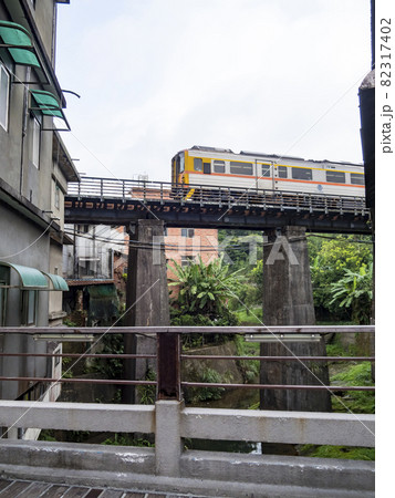 Train of Pingxi Railway Line traveling in Pinghsi old street, New Taipei City, Taiwan 82317402
