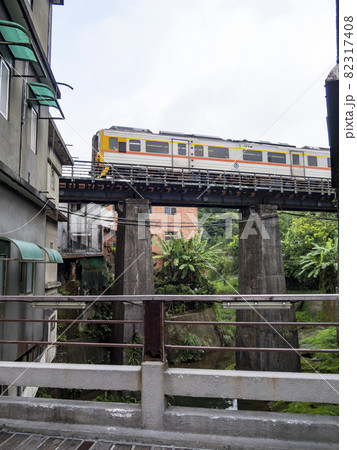 Train of Pingxi Railway Line traveling in Pinghsi old street, New Taipei City, Taiwan 82317408