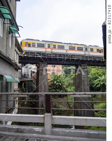 Train of Pingxi Railway Line traveling in Pinghsi old street, New Taipei City, Taiwan 82317410