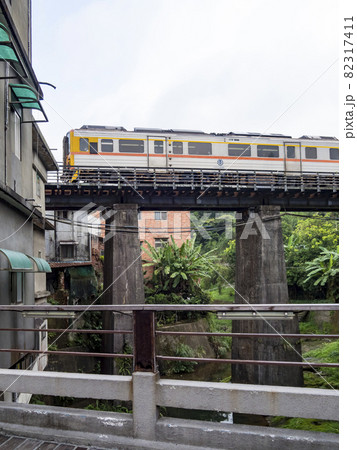 Train of Pingxi Railway Line traveling in Pinghsi old street, New Taipei City, Taiwan 82317411