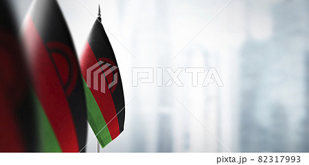 Small flags of Malawi on a blurry background of the city 82317993