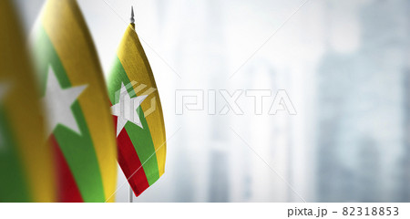 Small flags of Myanmar on a blurry background of the city Small flags of Myanmar on a blurry background of the city 82318853