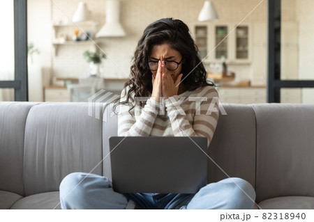 Deadline stress. Desperate young woman crying near laptop, having trouble performing work task, making mistake at home Deadline stress. Desperate young woman crying near laptop, having trouble performing work task, making mistake at home 82318940