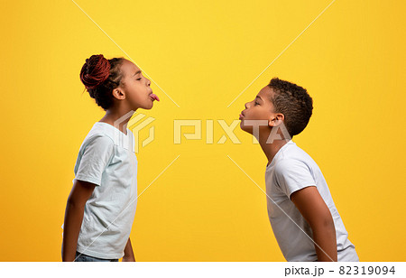 Naughty black brother and sister having fight, showing tongues Naughty black brother and sister having fight, showing tongues 82319094