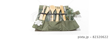 Christmas banner with set of eco friendly cutlery and hygiene products in case with snowflake and fir twig on white. 82320622