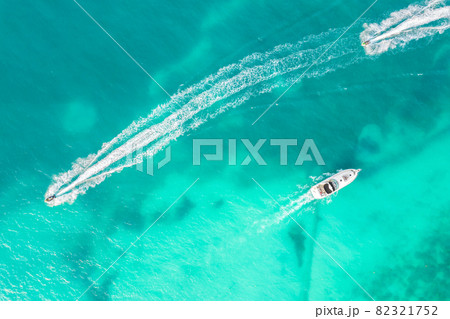 Amazing top view of yacht. Aerial view of luxury floating small ship in blue Caribbean sea. Yacht at the sea in Cancun in Mexico Amazing top view of yacht. Aerial view of luxury floating small ship in blue Caribbean sea. Yacht at the sea in Cancun in Mexico 82321752