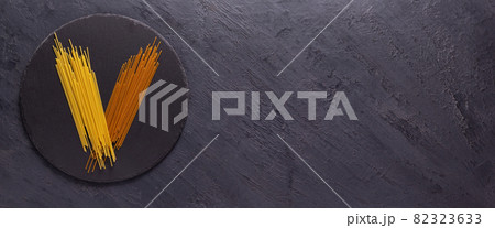 Pasta spaghetti food on table background. Raw pasta at slate stone 82323633