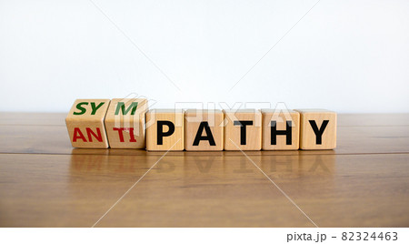 From antipathy to sympathy. Turned cubes and changed the word 'antipathy' to 'sympathy'. Beautiful wooden table, white background. Copy space. Psychological and antipathy or sympathy concept. 82324463