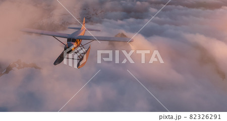 Seaplane flying around the clouds and mountains. 82326291