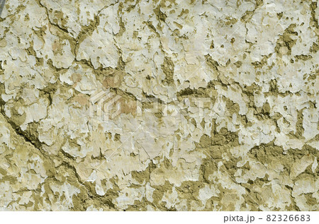 Clay wall. Wall background with shabby paint and crack, old hut wall. Cracks in the wall of a hut. Abstract background 82326683